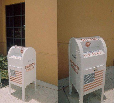 Two white mailboxes that say freedom eagles on them