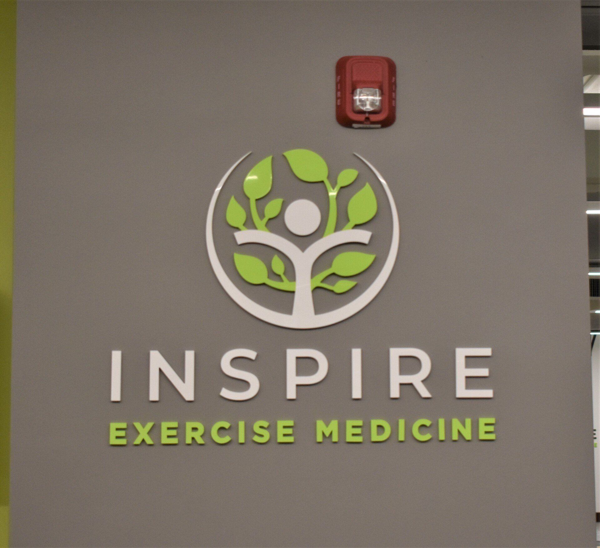 A sign that says inspire exercise medicine on it