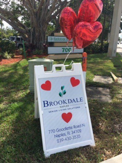 A brookdale sign with balloons in the shape of hearts