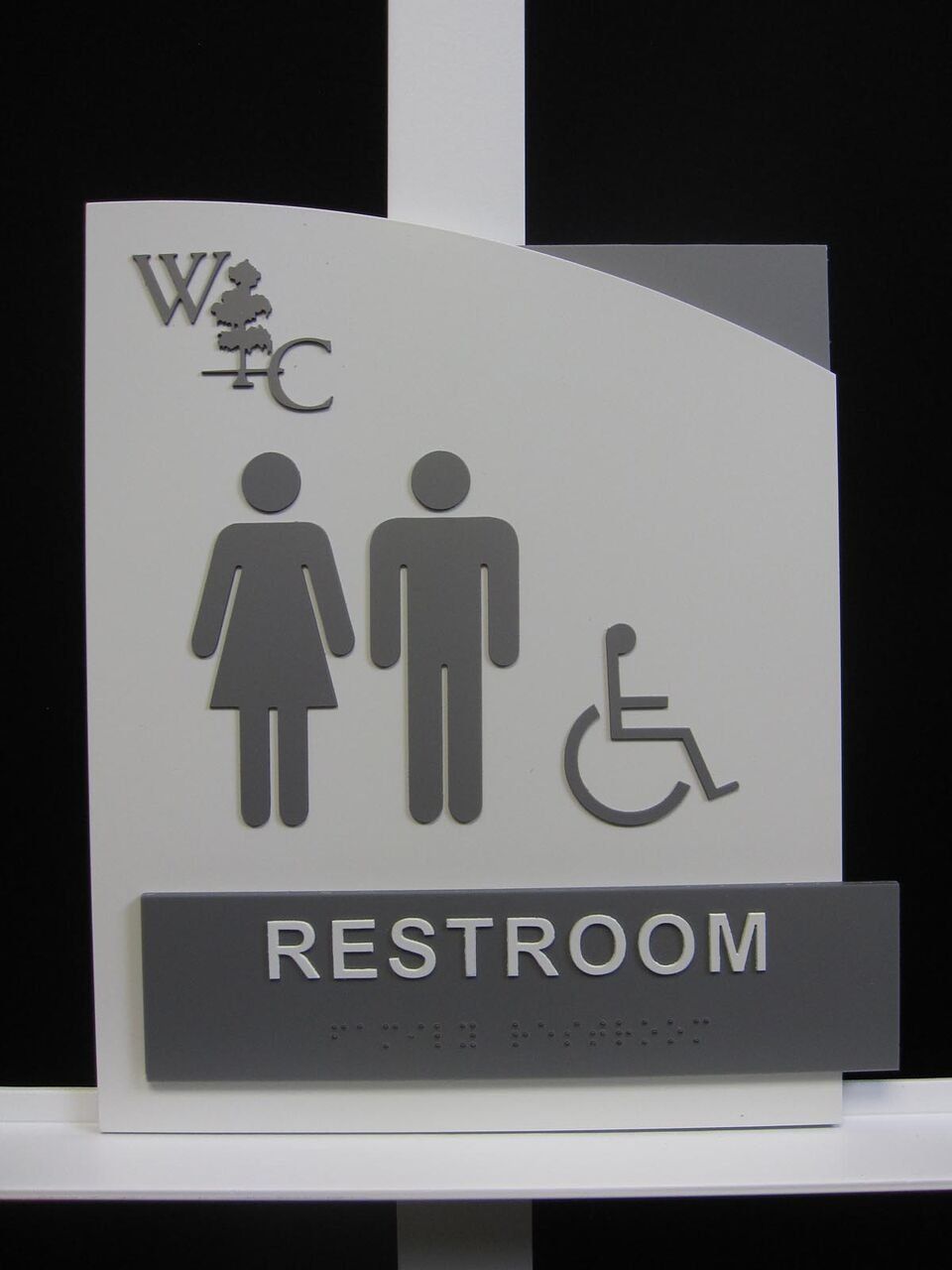A sign for a restroom with a handicapped person