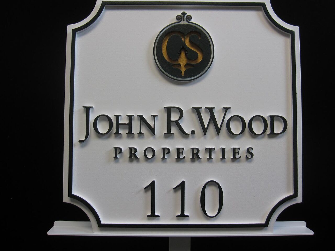 A sign that says john r. wood properties on it