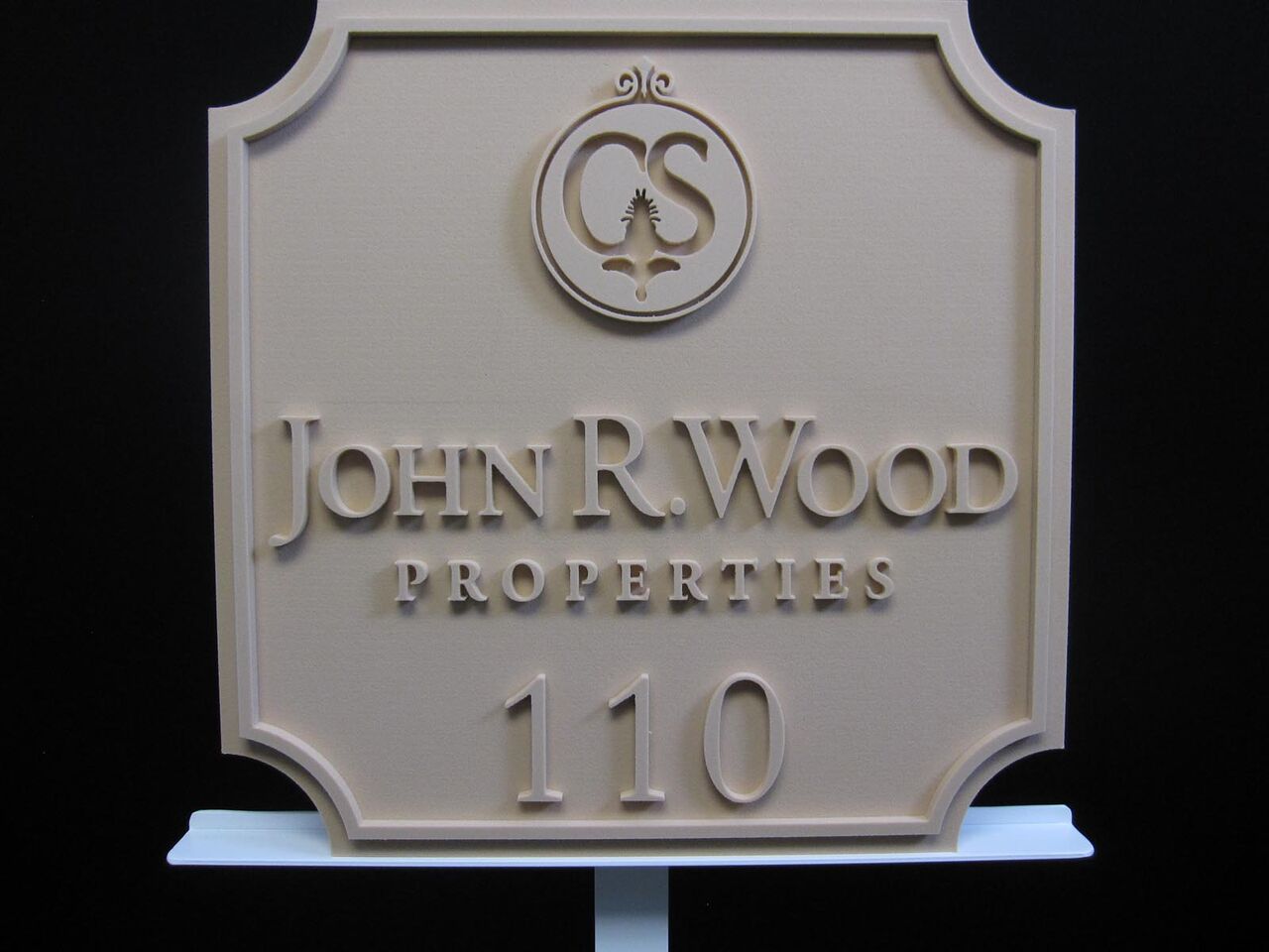 A sign that says john r wood properties on it