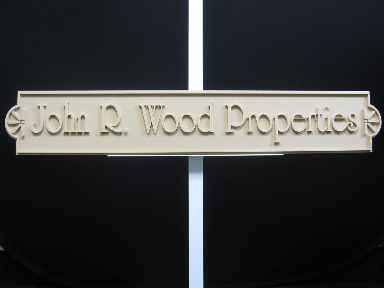 A sign that says john r. wood properties on it