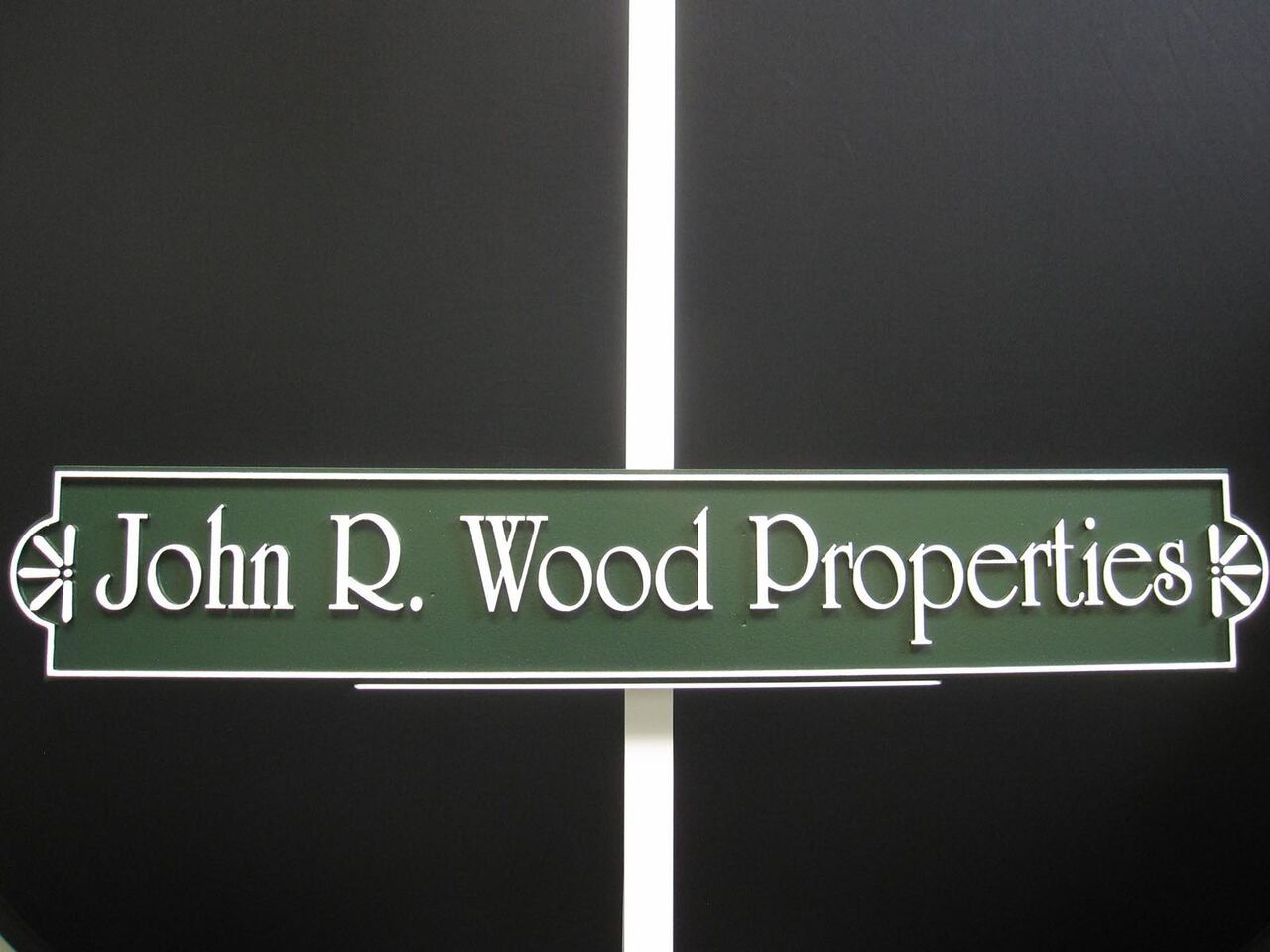 A sign that says john r. wood properties on it