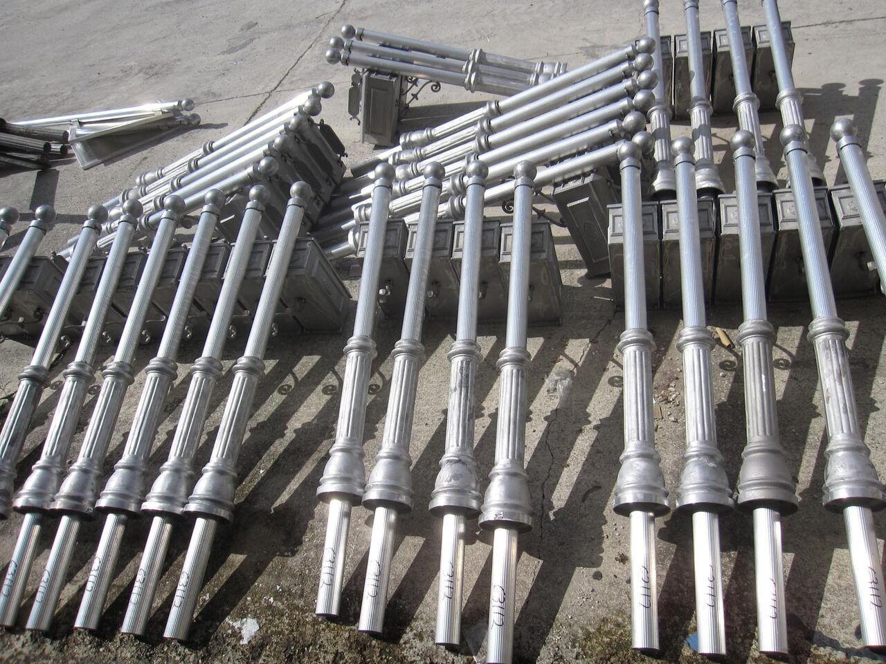A bunch of metal poles are lined up on the ground