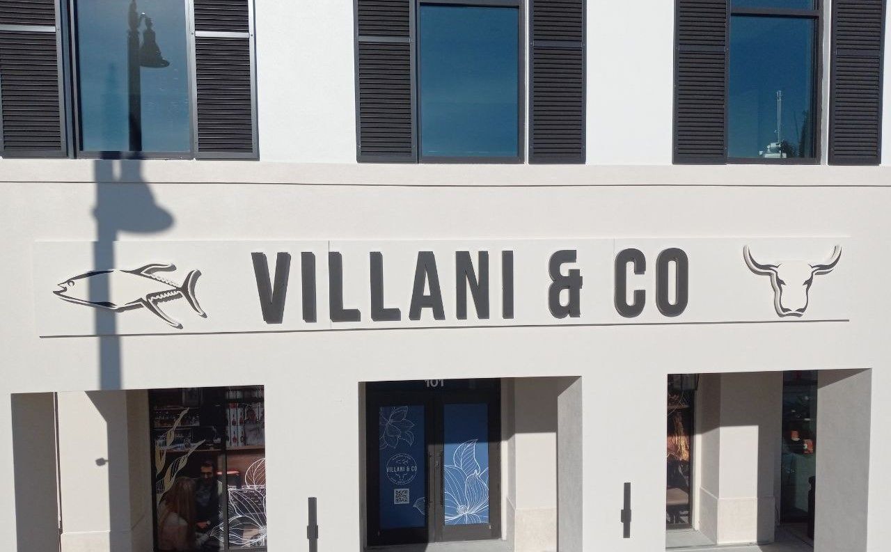 A white building with a sign that says villani & co