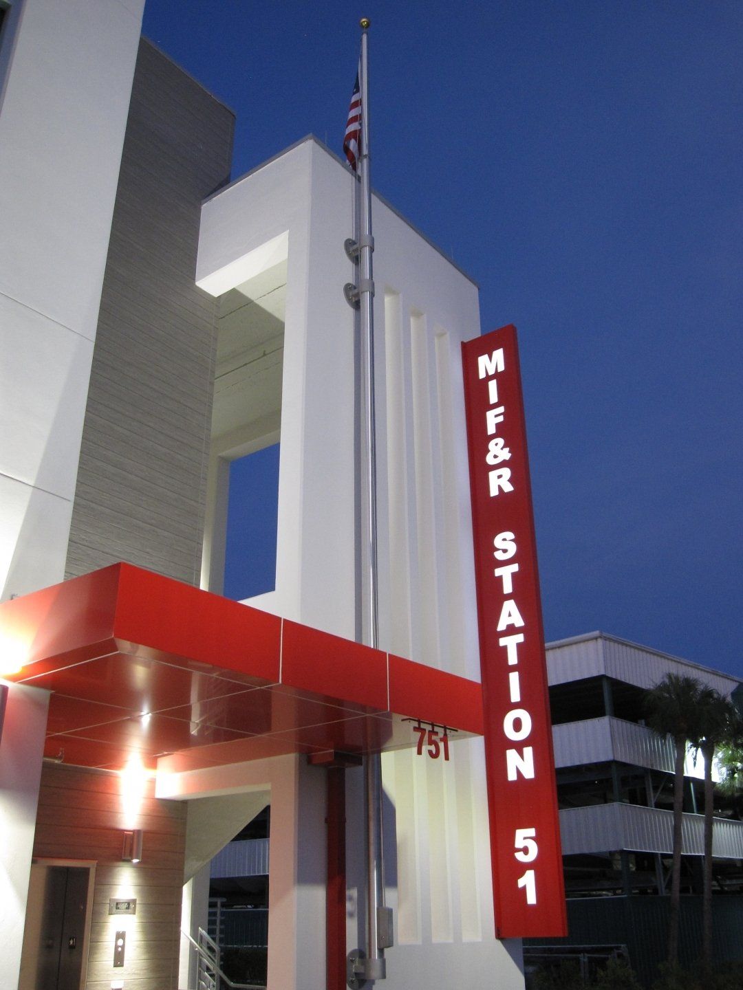 A white building with a red sign that says mifar station 51