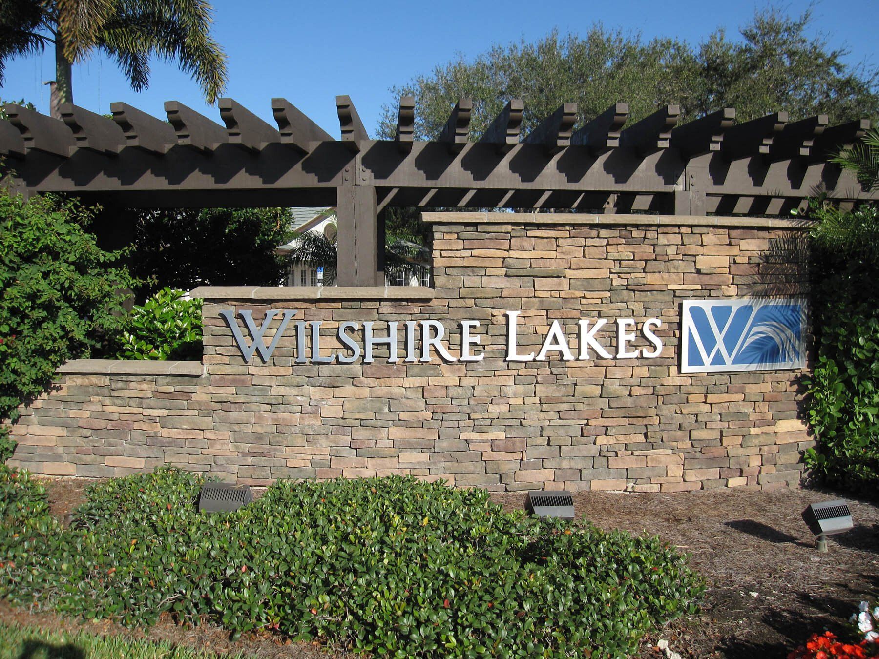 A sign that says wilshire lakes on it