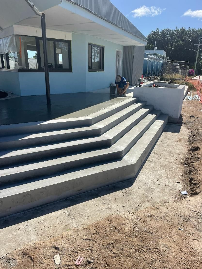 Construction Workers Building a New Concrete Driveway at A Residential Property — Fallon Constructions NQ
 in Fredericksfield, QLD