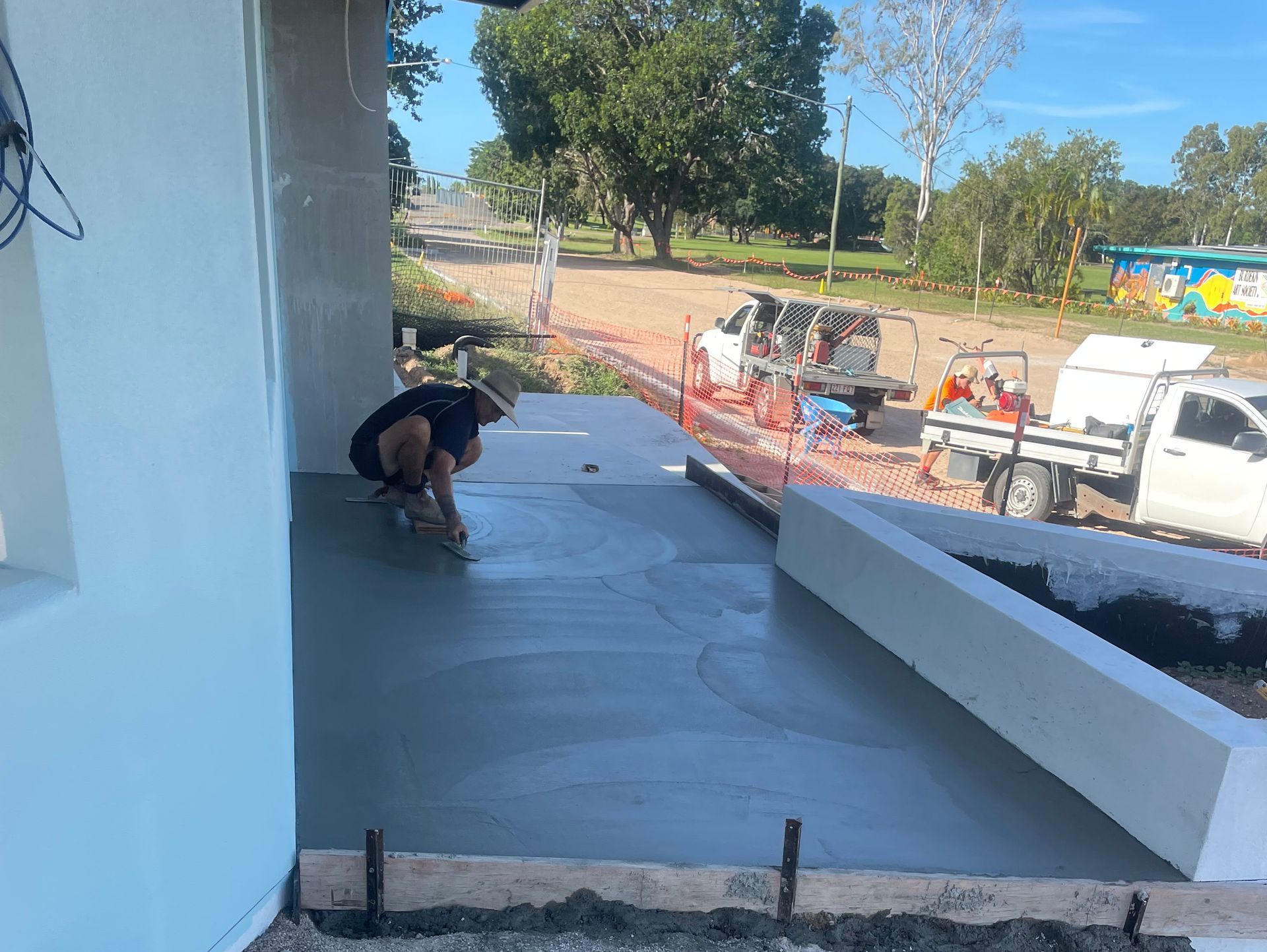 Workers Levelling Concrete Pavement During Construction — Fallon Constructions NQ in Fredericksfield, QLD