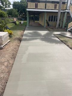 A Concrete Walkway Is Being Built Next to A Fence — Fallon Constructions NQ in Fredericksfield, QLD