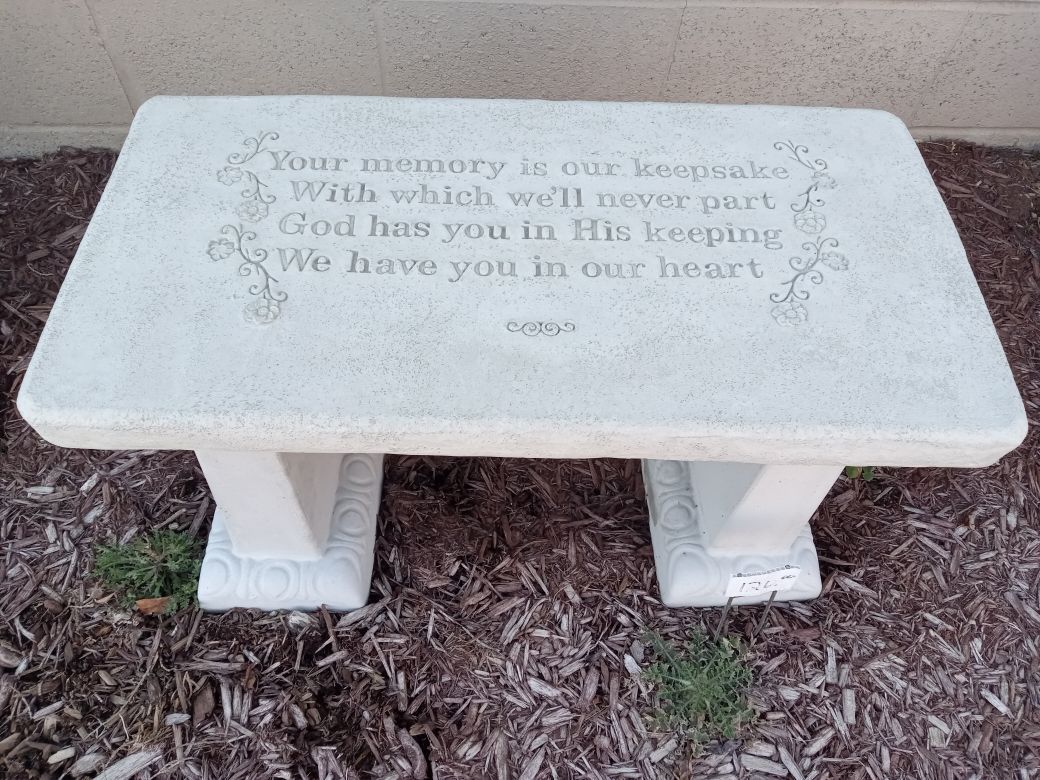 Stone bench with inscribed memorial quote: 