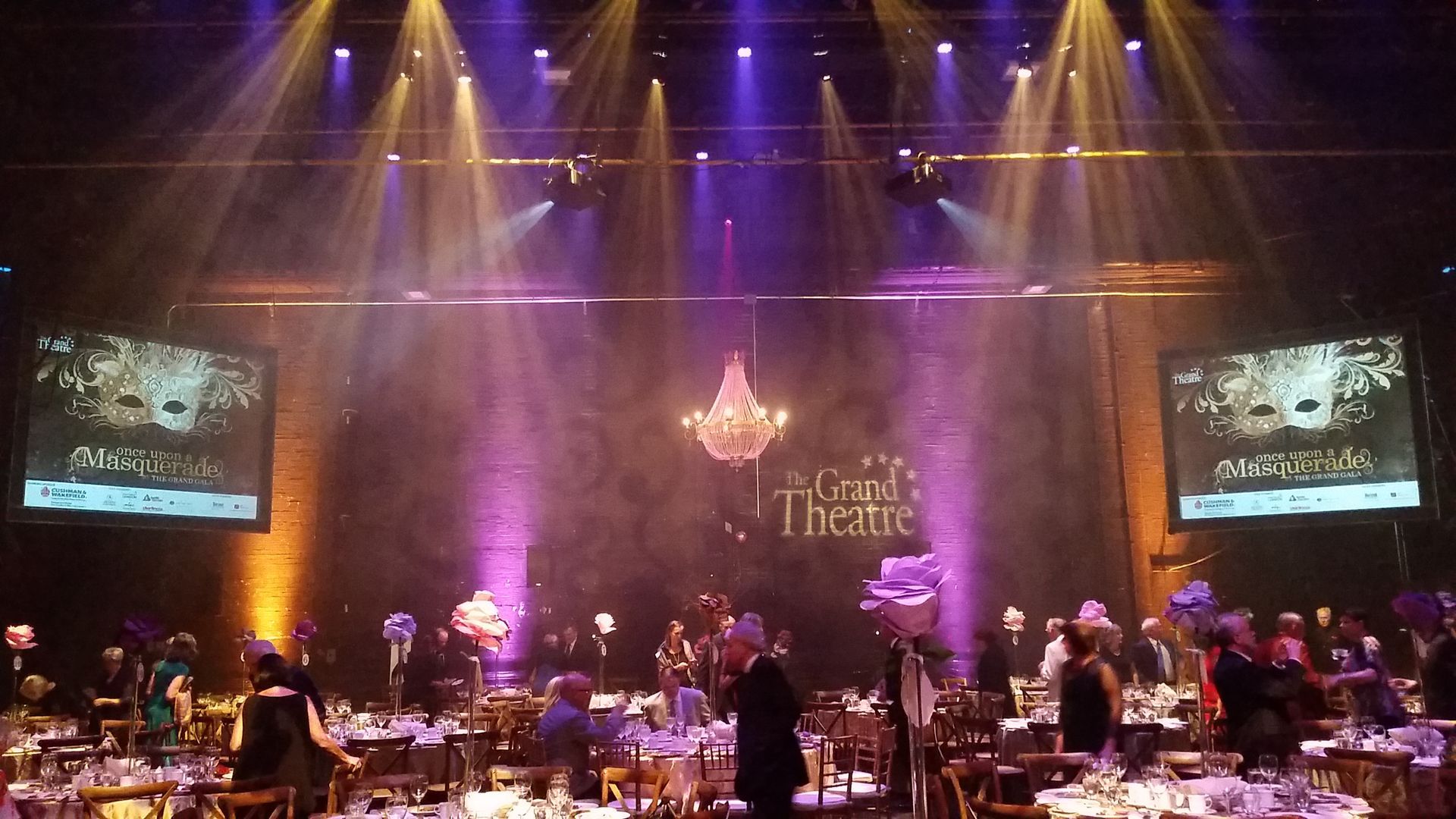 The grand theatre is lit up with purple lights