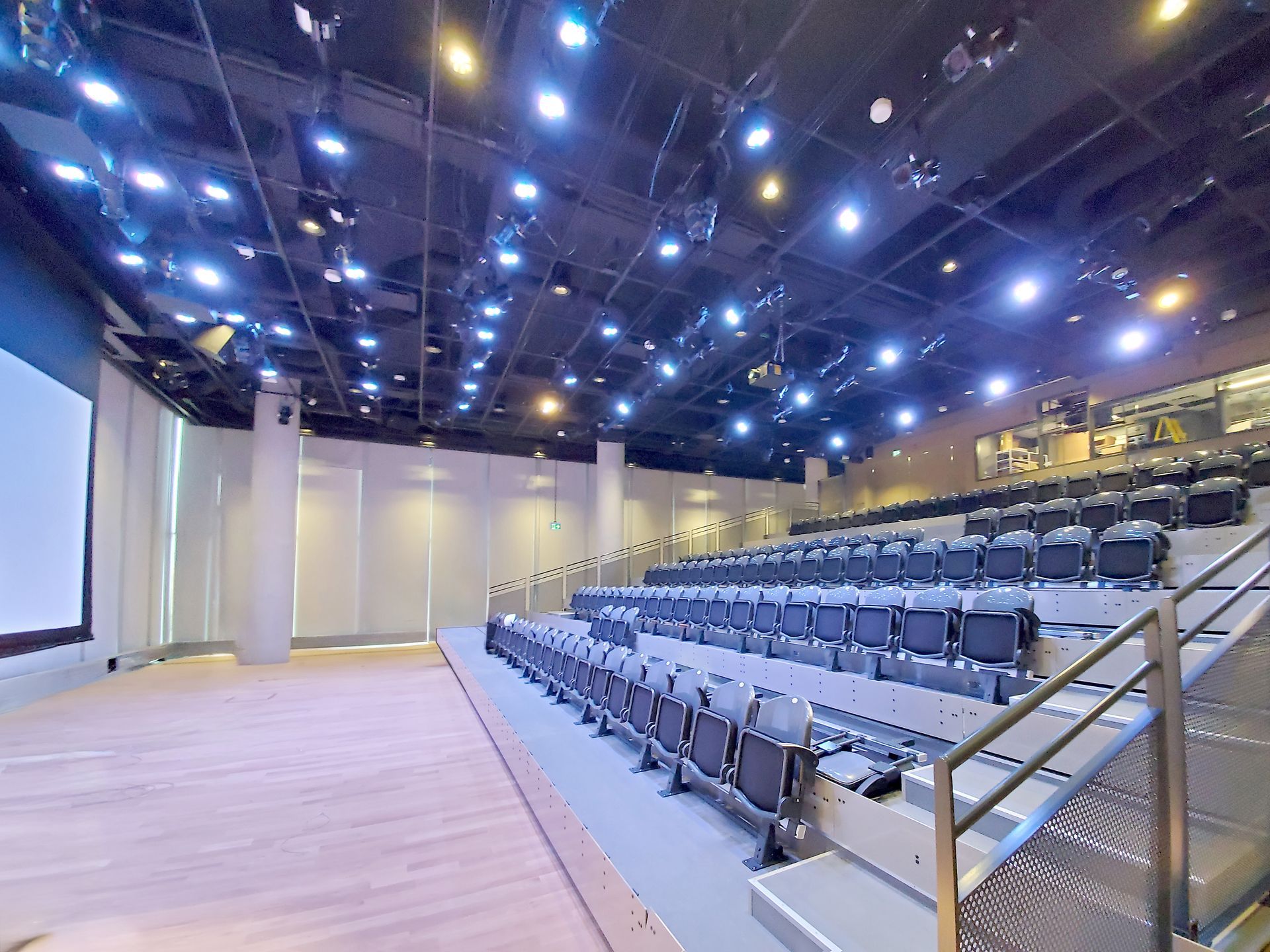 A large empty auditorium with rows of seats and stairs.