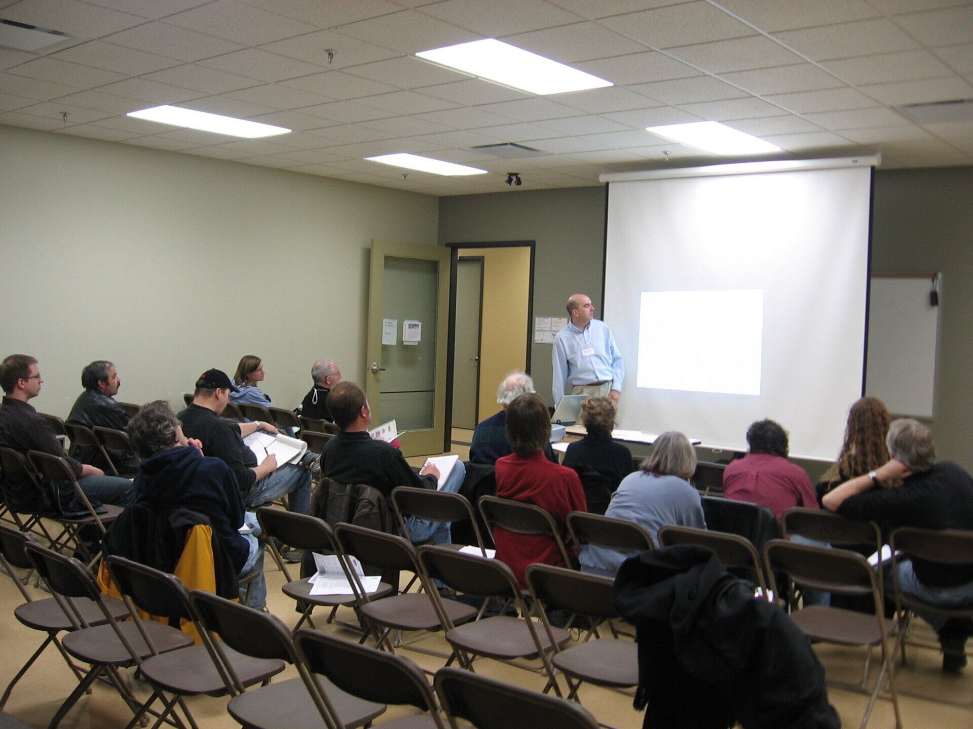 A man is giving a presentation to a group of people