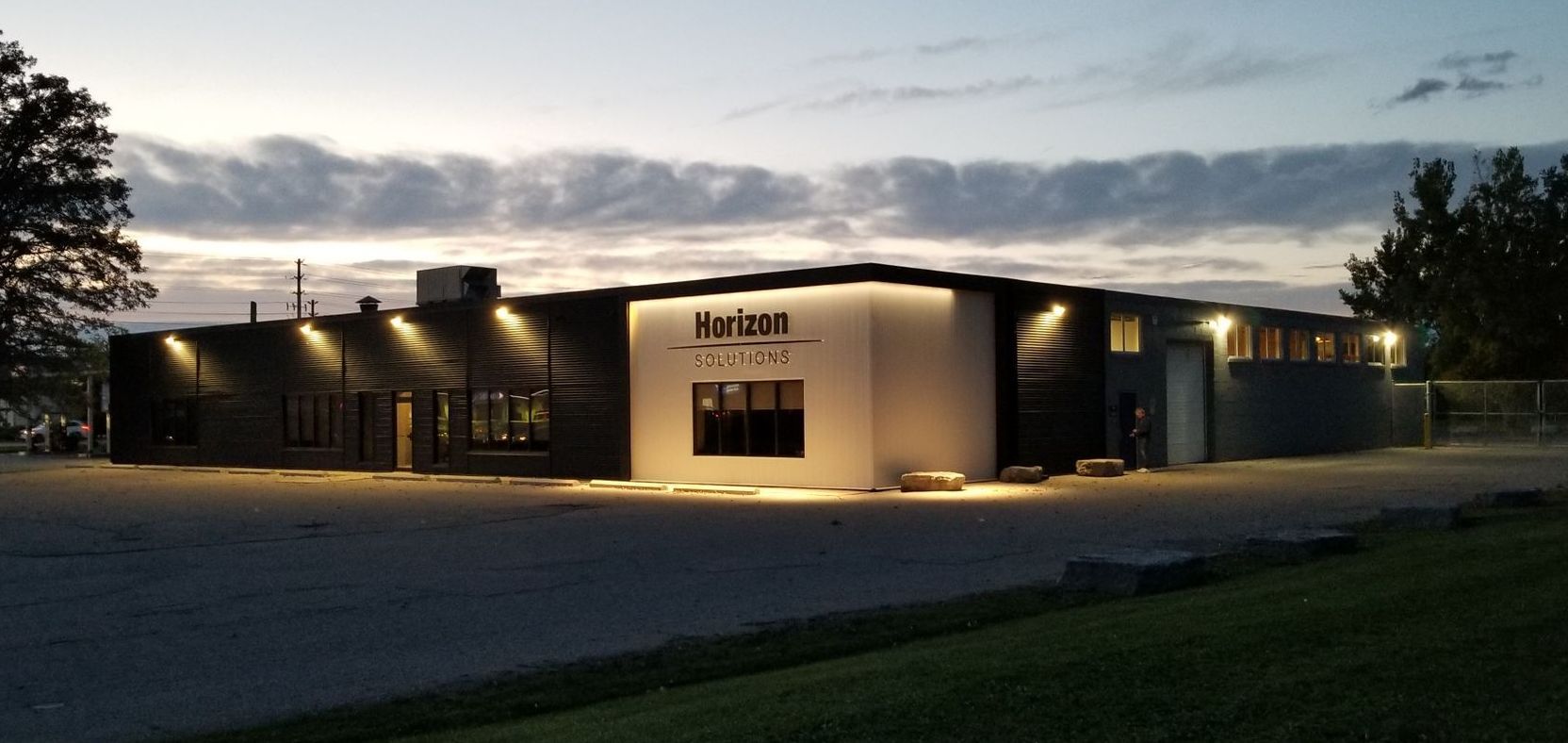 Horizon Solutions Office Building lit up at night.