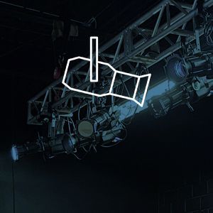 A bunch of spotlights are hanging from a metal structure in a dark room.