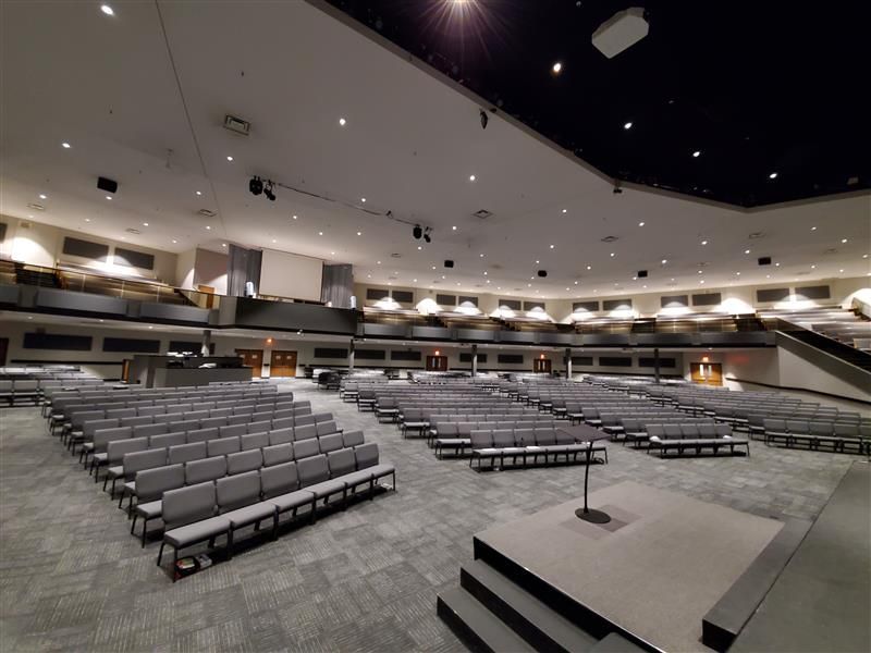 A large auditorium with rows of seats and a stage