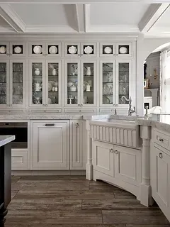 A kitchen with white cabinets , a sink , and a dishwasher.