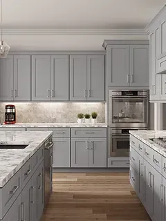 A kitchen with gray cabinets , marble counter tops , and stainless steel appliances.