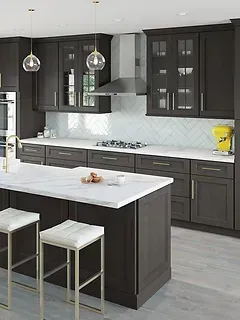 A kitchen with black cabinets , white counter tops , and a large island.