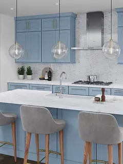 A kitchen with blue cabinets , a large island , stools and a stove.