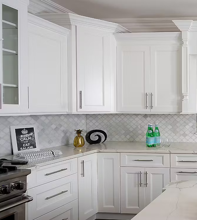 A kitchen with white cabinets and a stove top oven