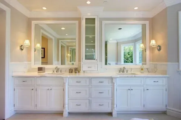 A bathroom with two sinks and two mirrors