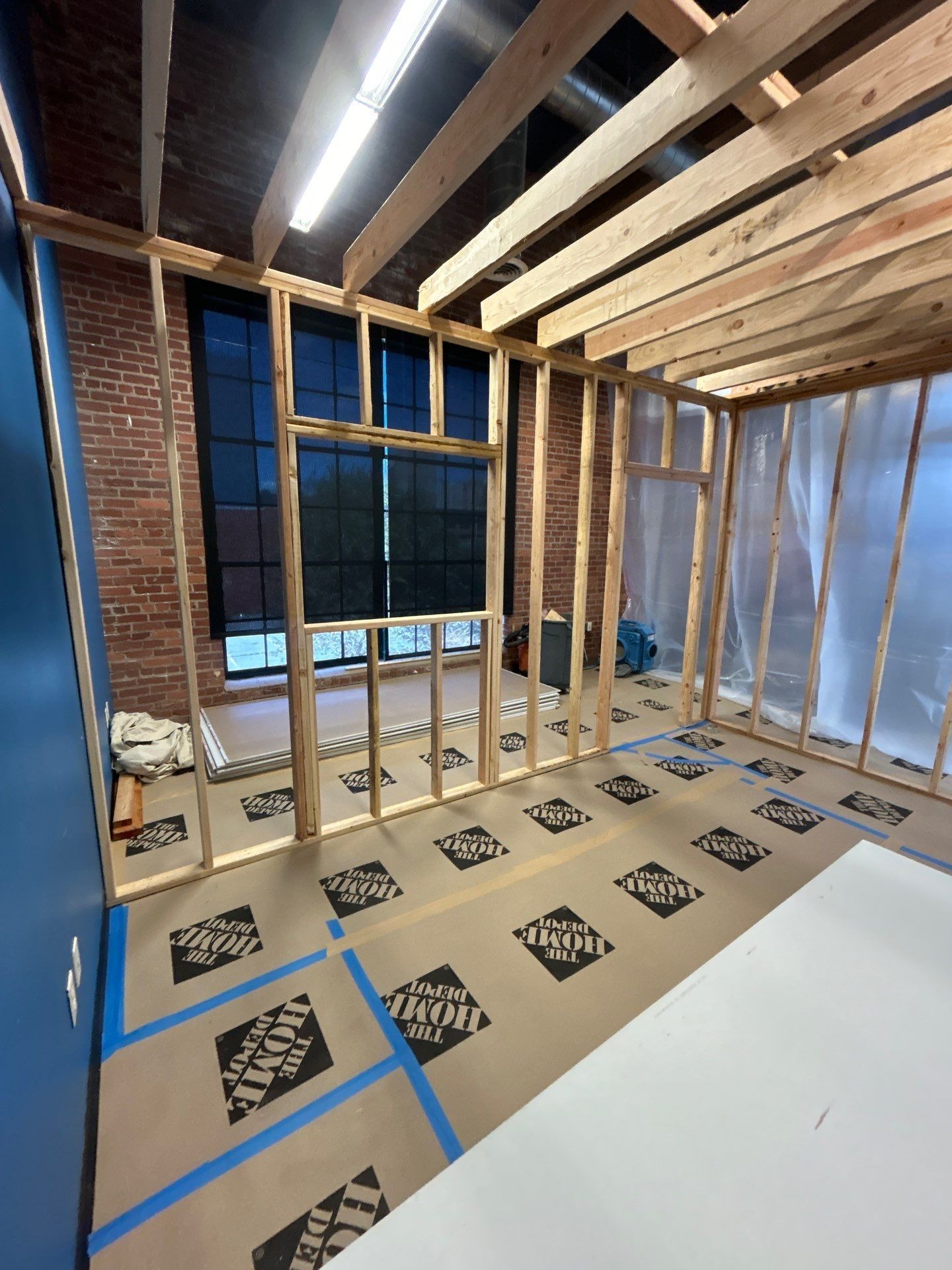 A room that is being built with a lot of wooden beams.