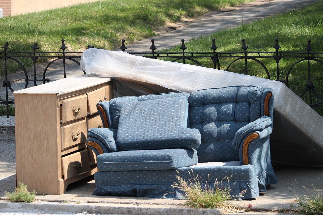 couch, mattress, and cupboard on the street curb