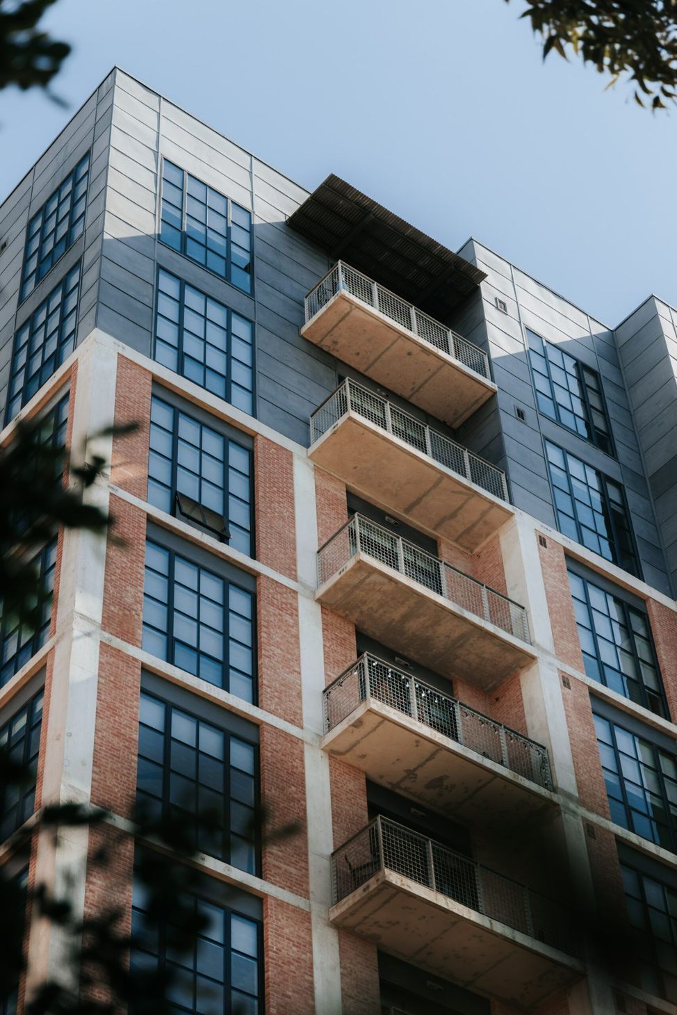 A tall building with a lot of windows and balconies