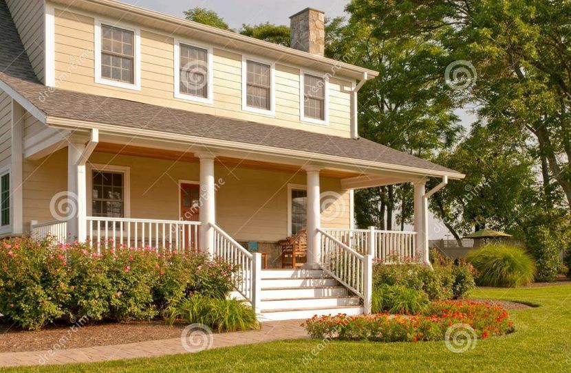 A large house with a large porch and stairs