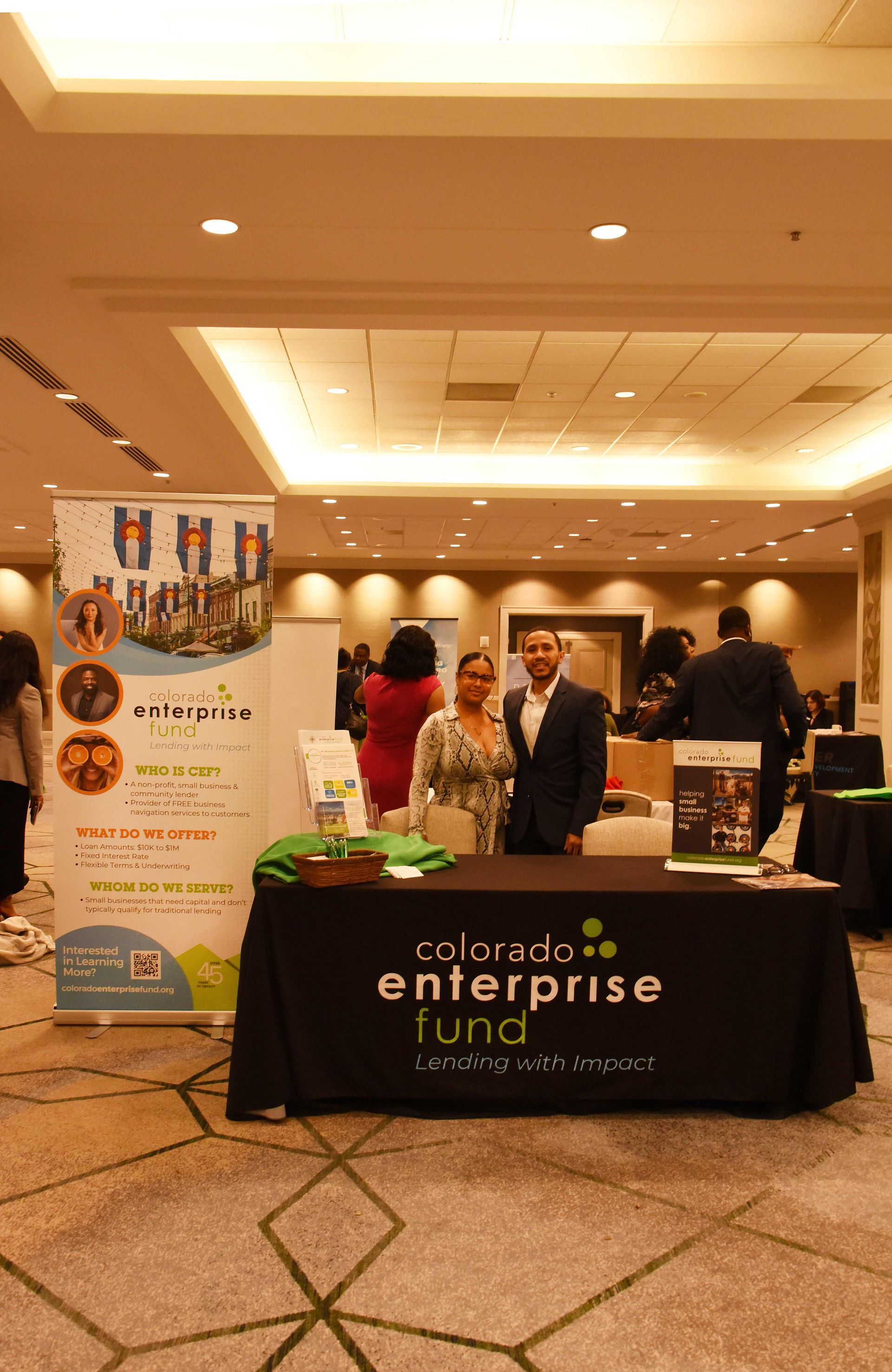 People standing around a table that says colorado enterprise fund