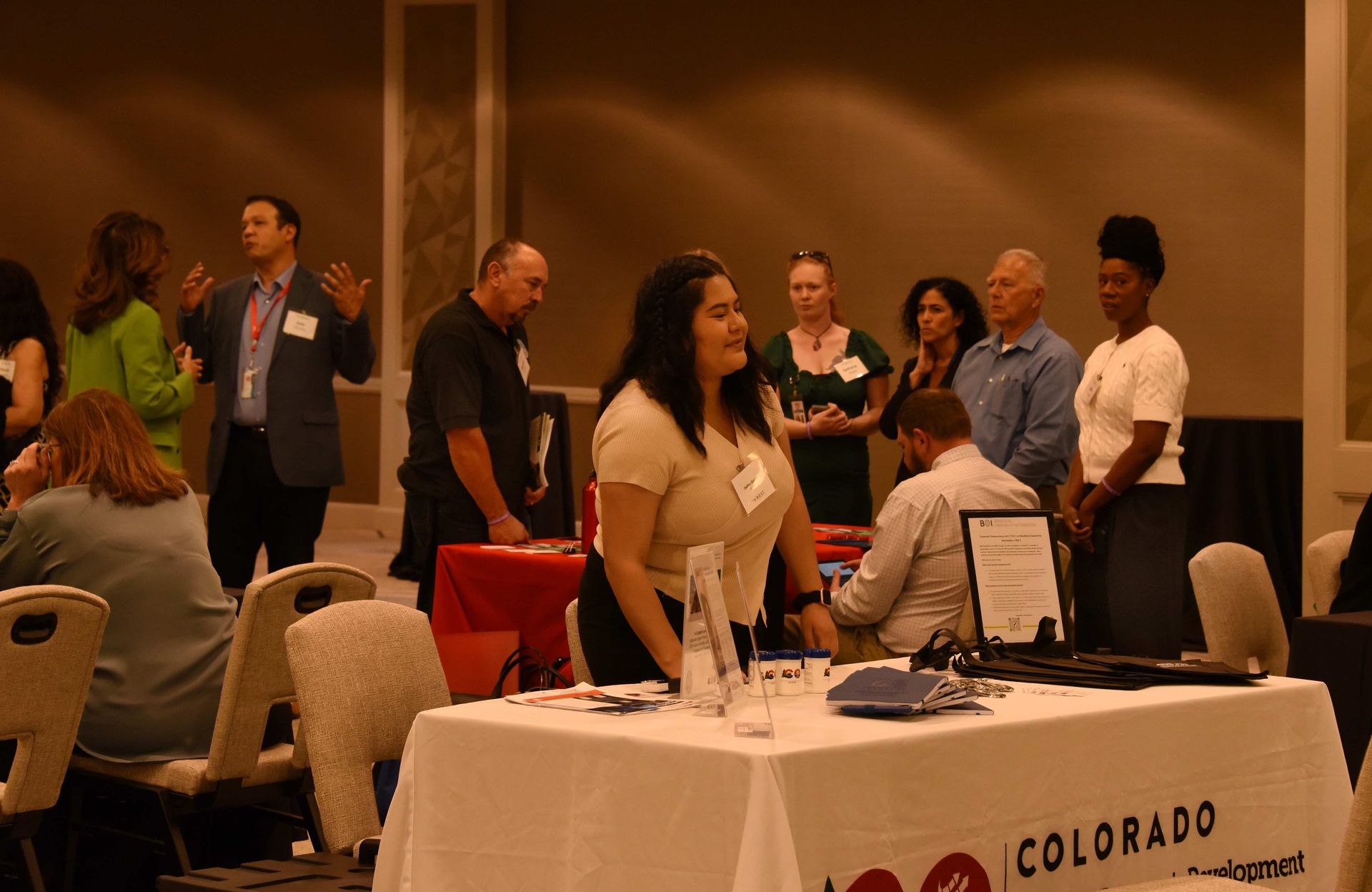 A group of people are standing around a table in a room.