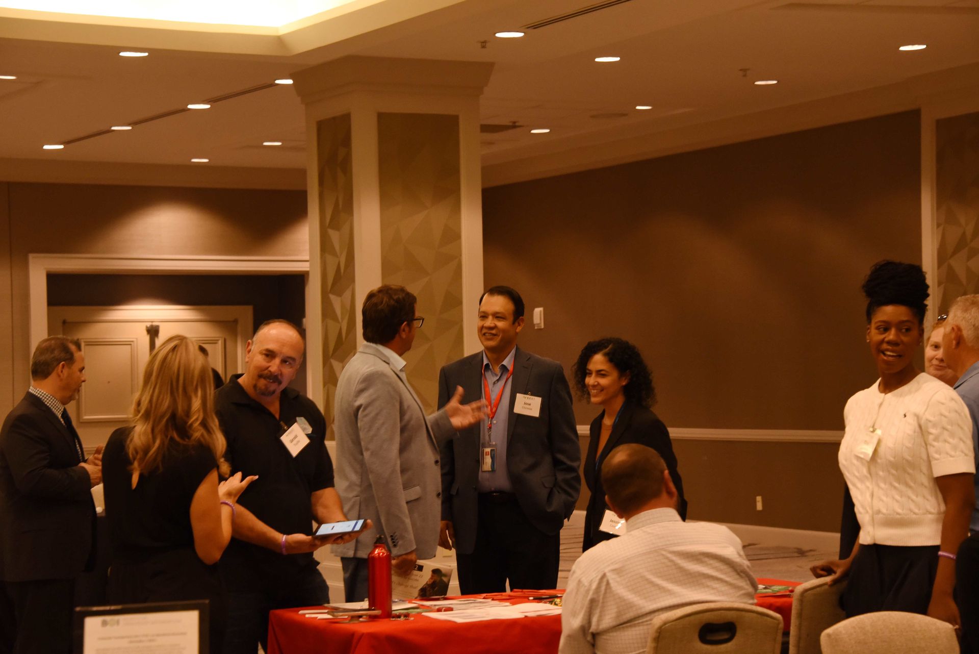A group of people are standing around a table in a room.