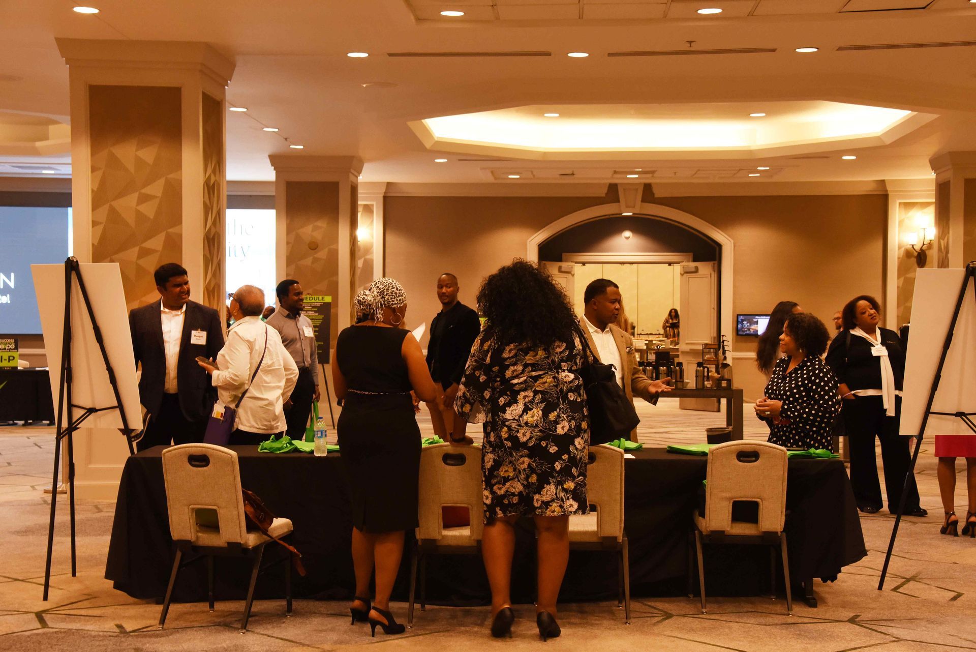 A group of people are standing around a table in a room.