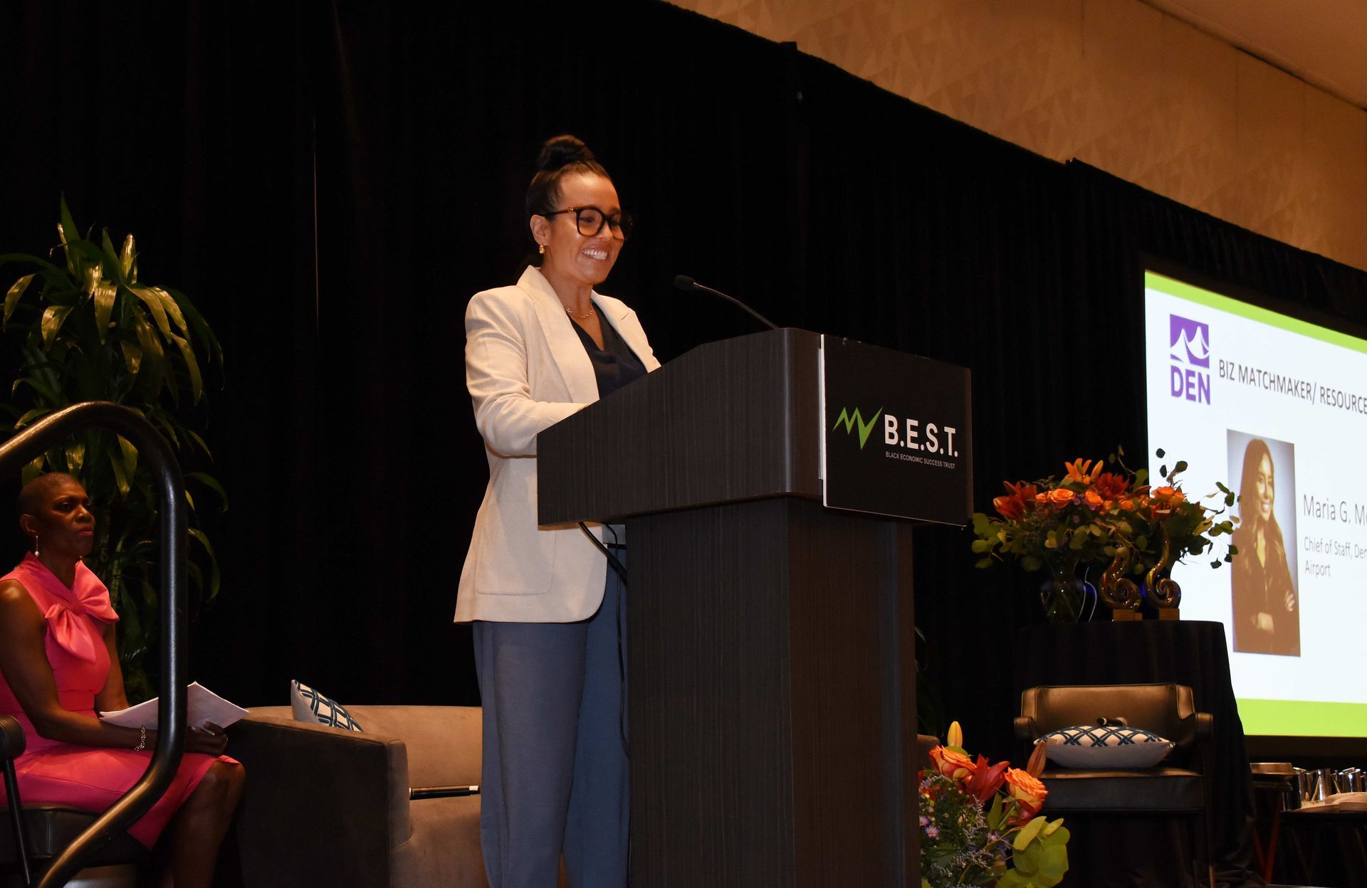A woman is standing at a podium giving a speech.