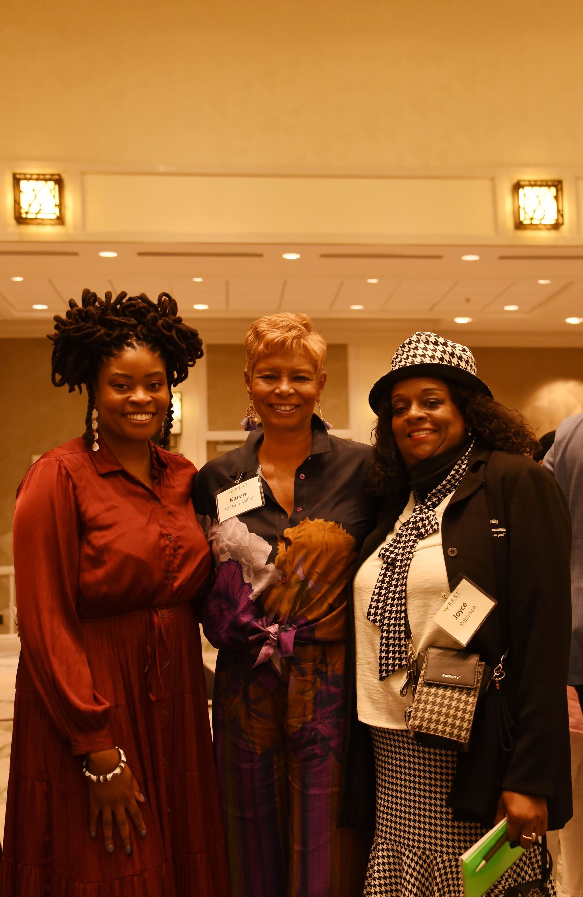 Three women are posing for a picture together in a room.