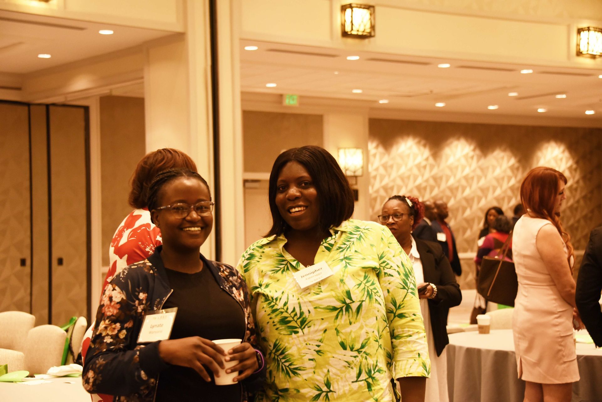 Two women are posing for a picture in a room.