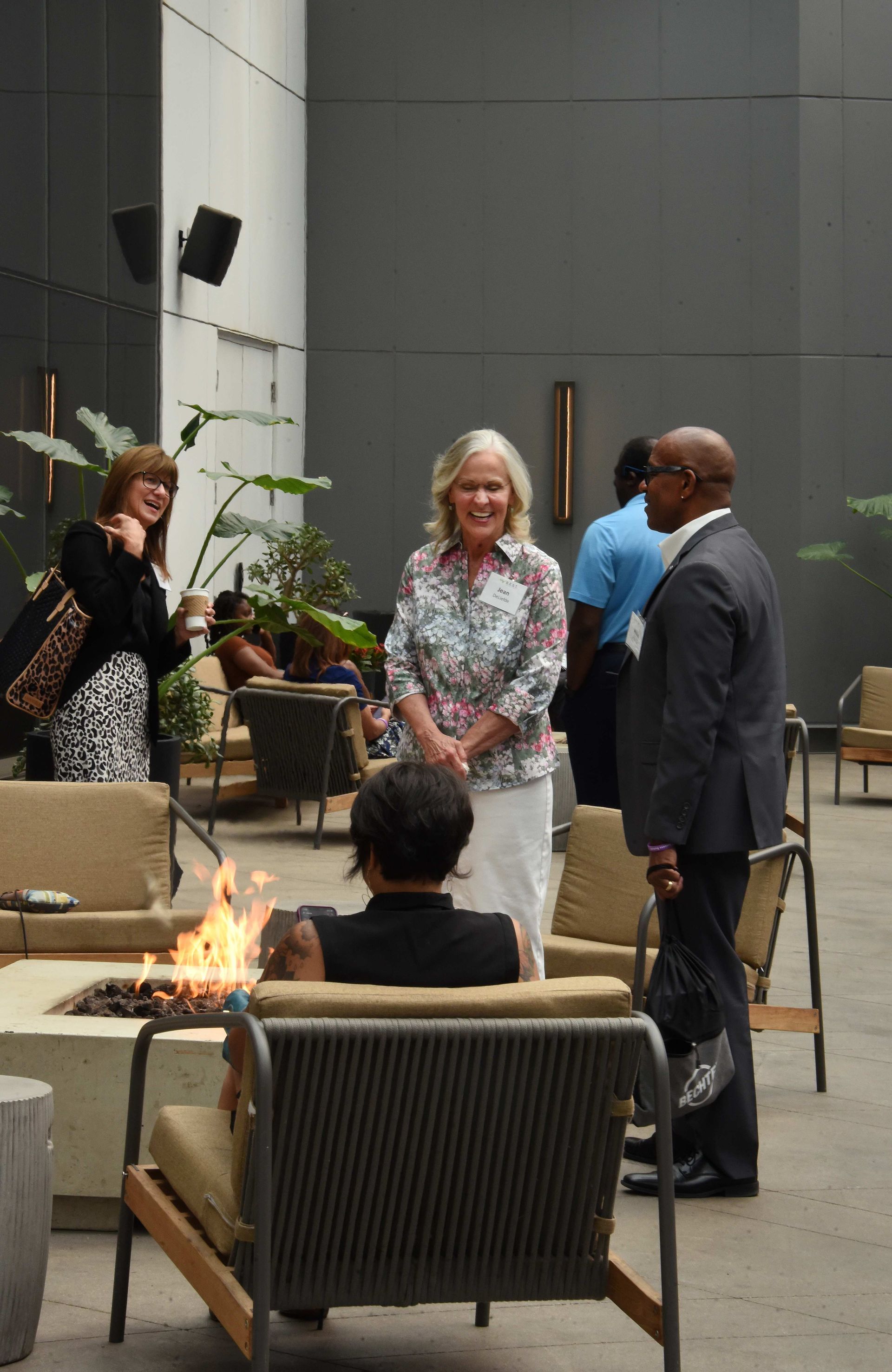 A group of people are standing around a fire pit
