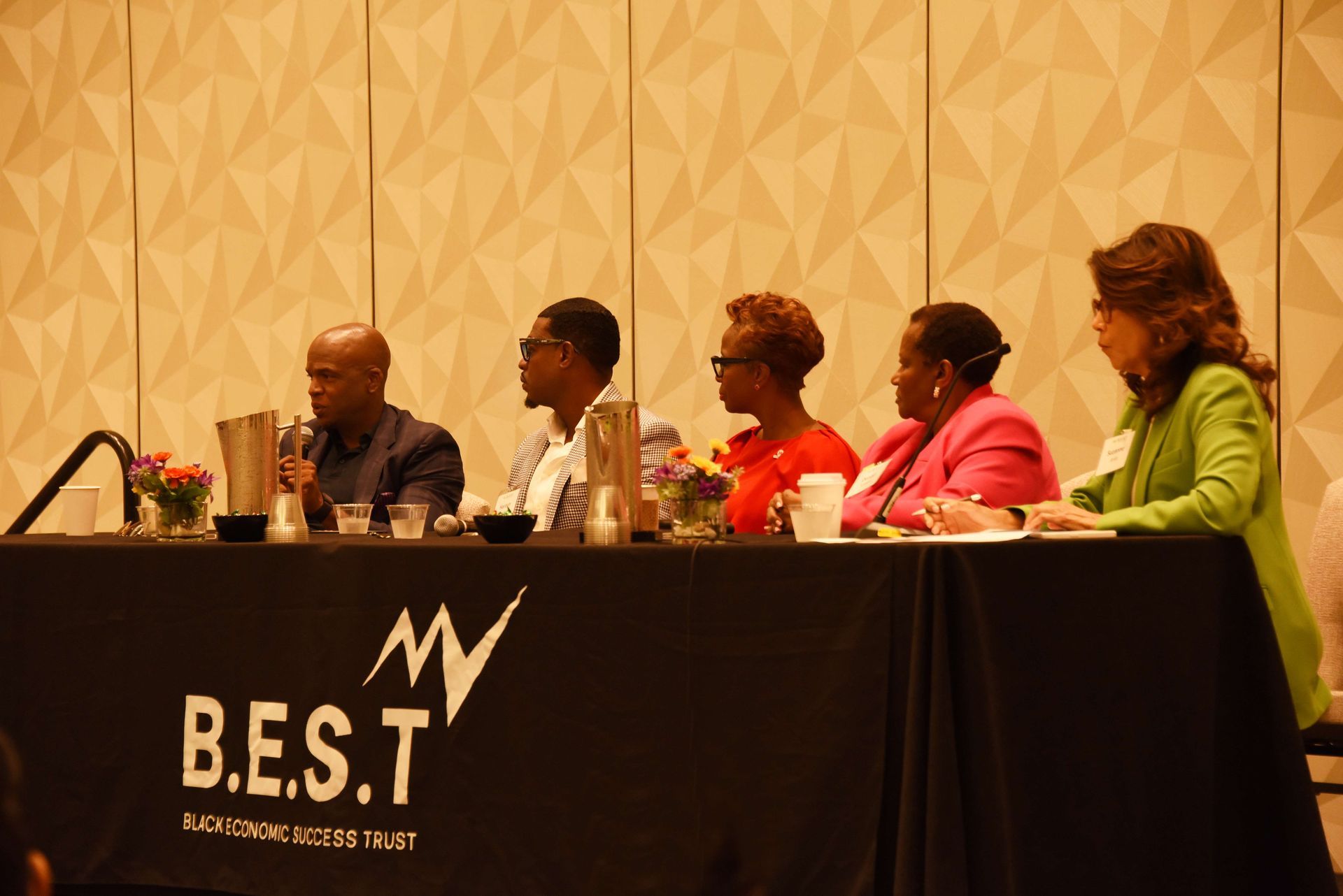 A group of people are sitting at a table with the word best on it.