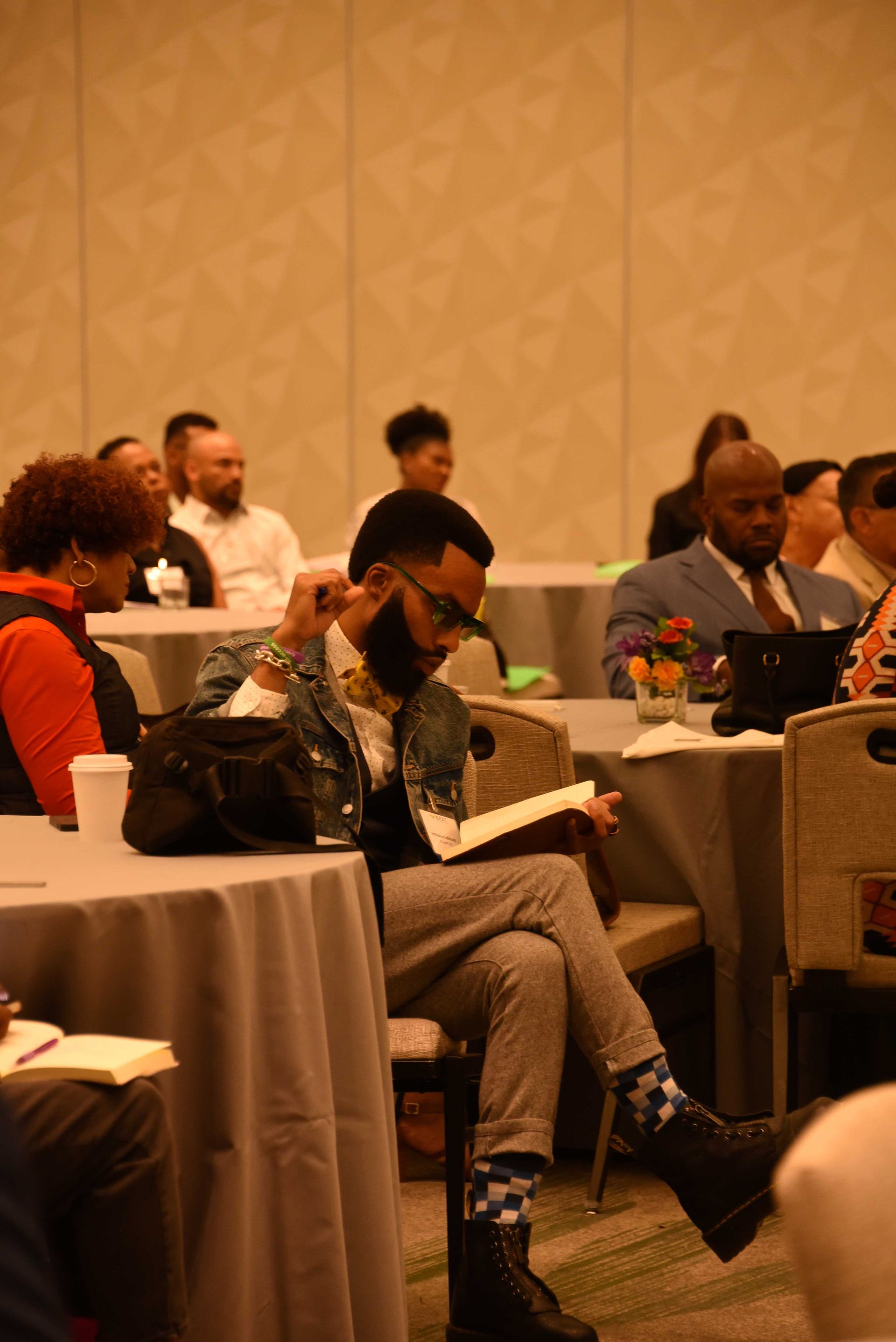 A group of people are sitting at tables in a room.