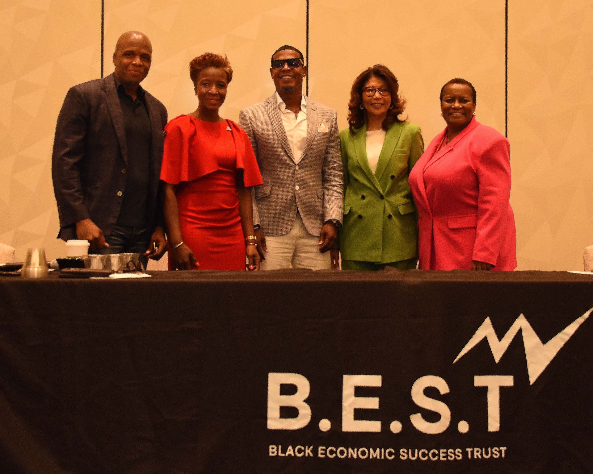 A group of people standing in front of a table that says b.e.s.t.