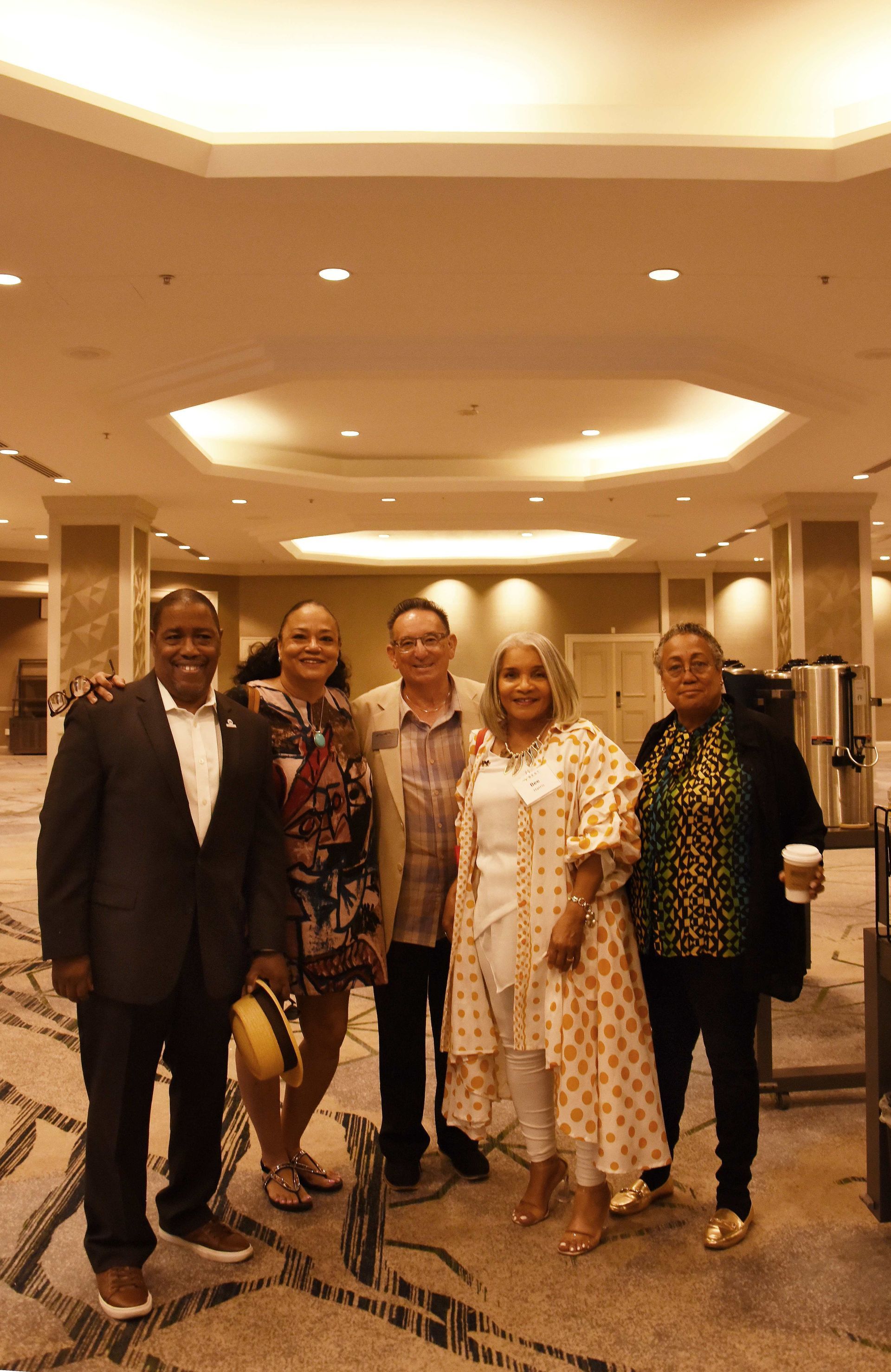 A group of people are posing for a picture in a room.