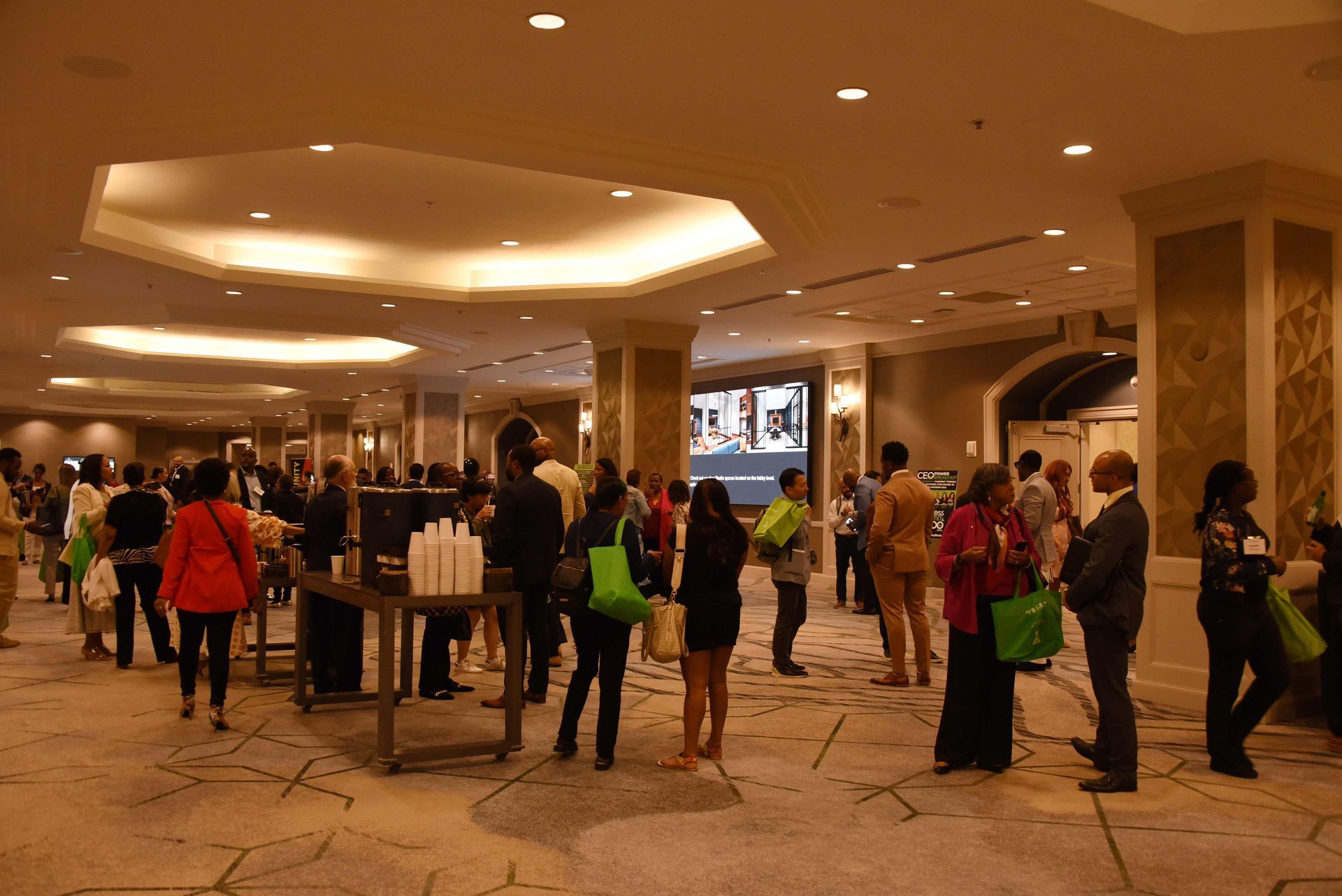 A group of people are standing in a large room