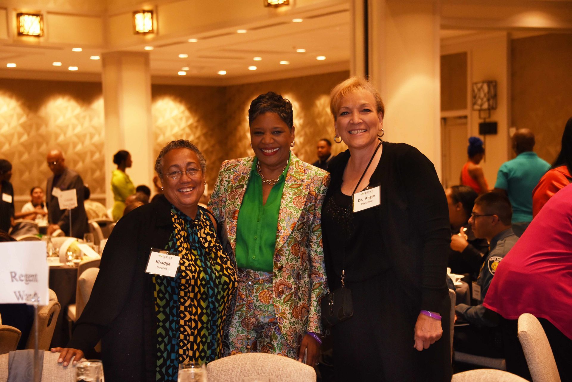 Three women are posing for a picture in a room