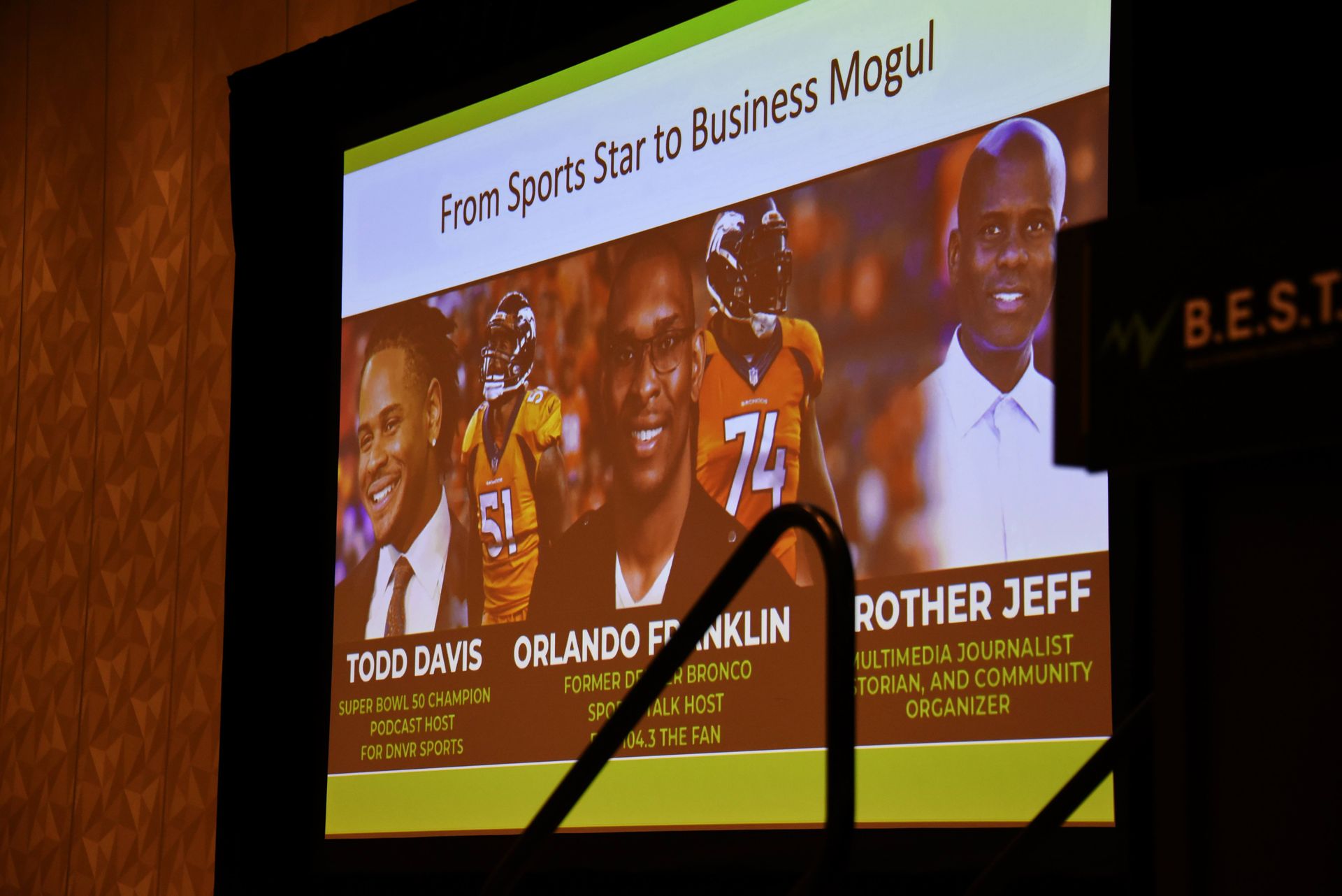 A projector screen with a picture of a football player and the words from sports star to business mogul