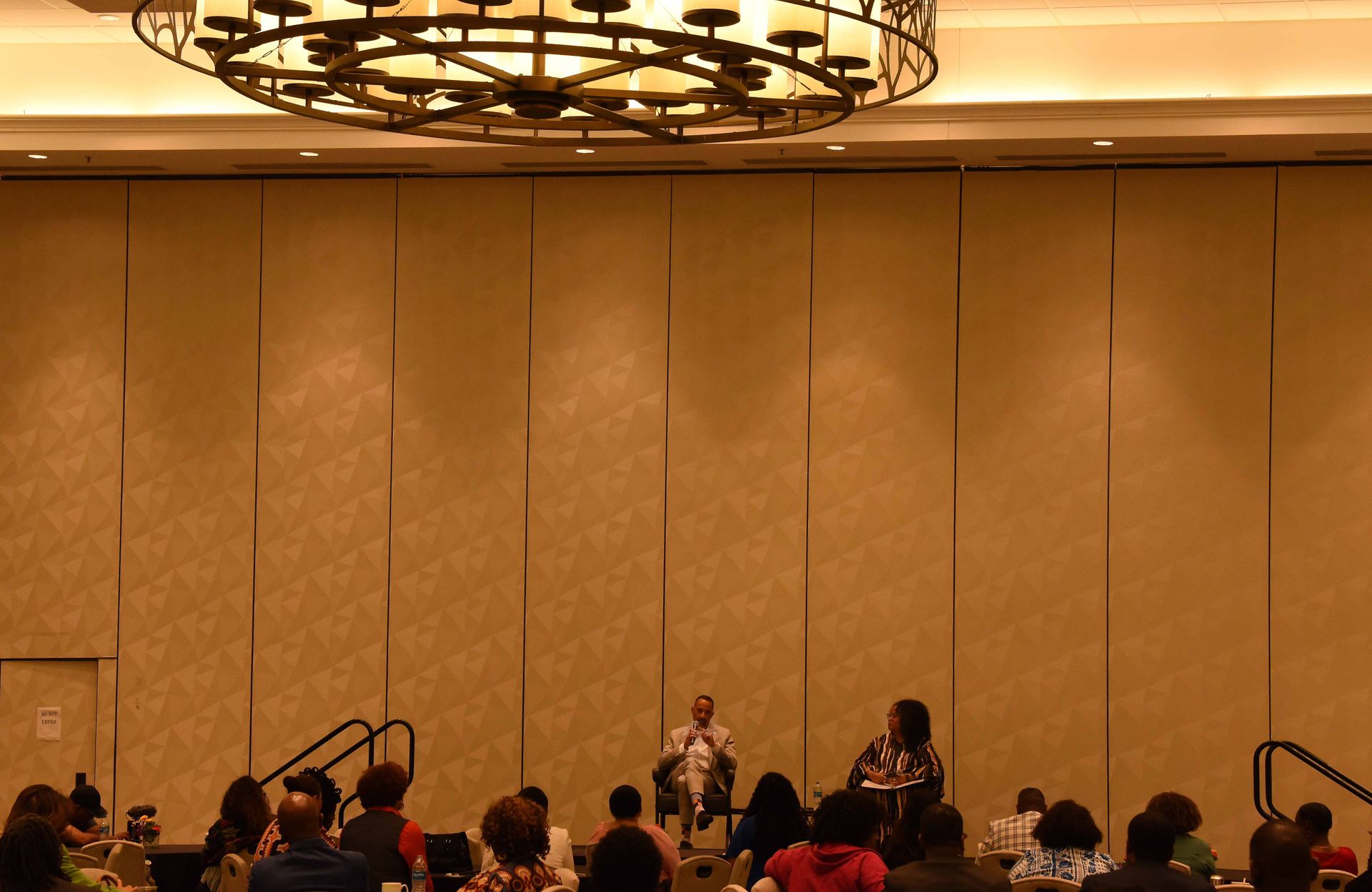 A man is giving a speech in front of a group of people