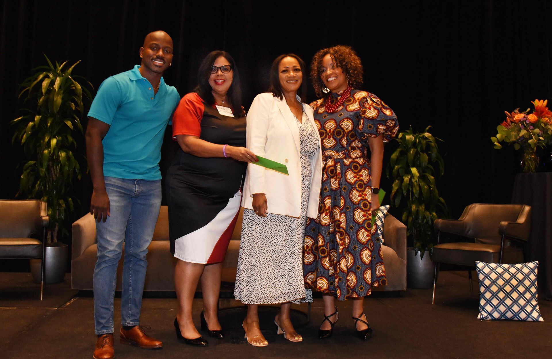 A group of people standing next to each other on a stage.