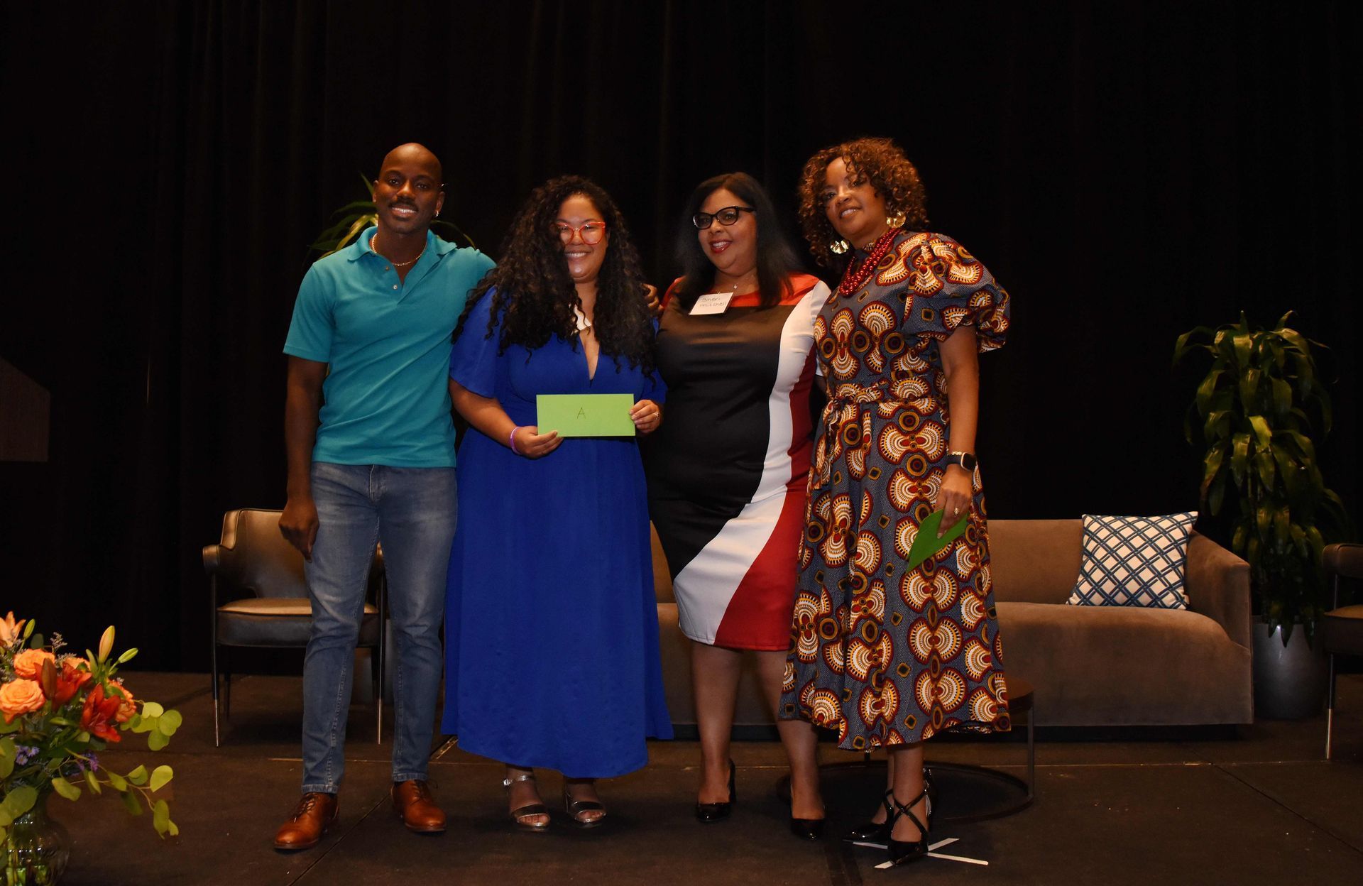 A group of people are posing for a picture on a stage.